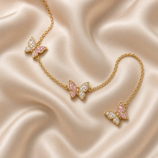 Gold chain bracelet with pink crystal butterfly charms